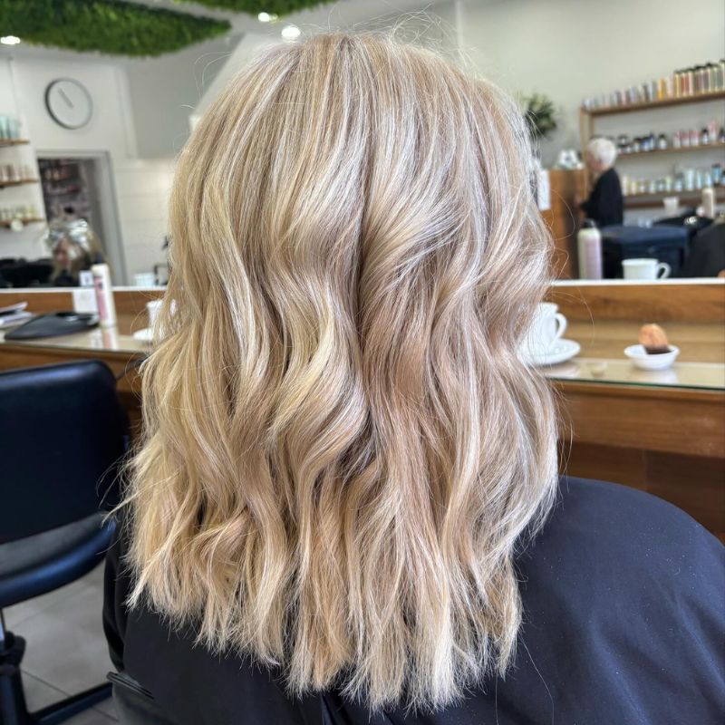 Elegant gift voucher display with flowers and premium hair products